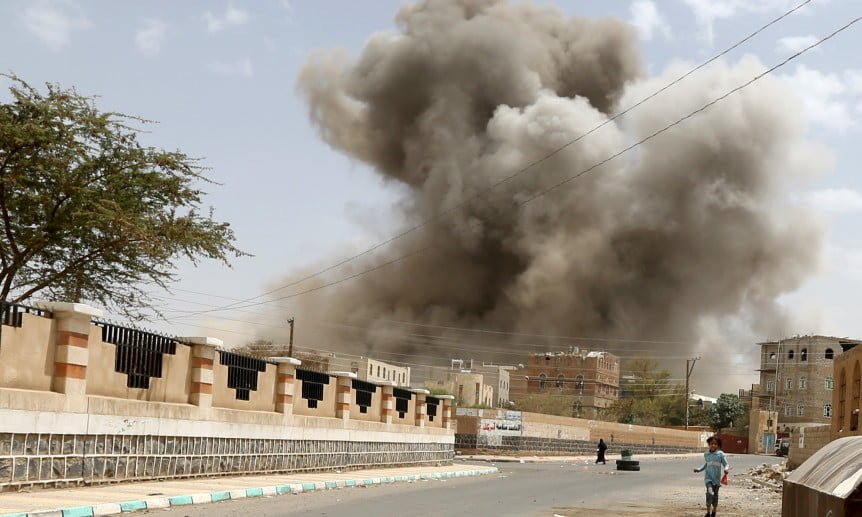 A girl runs for shelter during airstrike in Sanaa